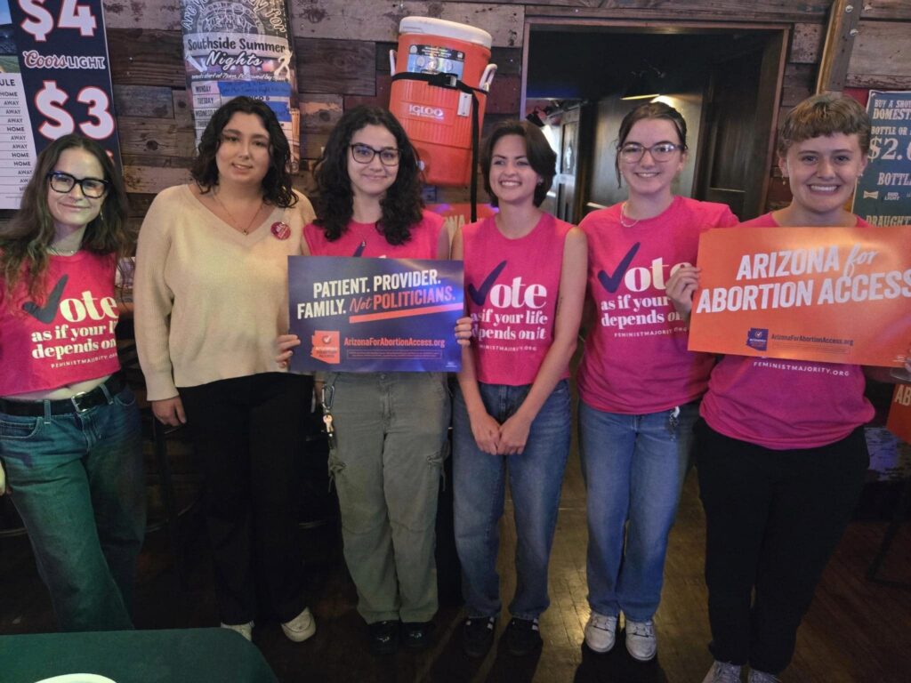 A group of young women Arizona Abortion Access volunteers in Flagstaff, AZ posing for a photo before canvassing for yes on prop 139