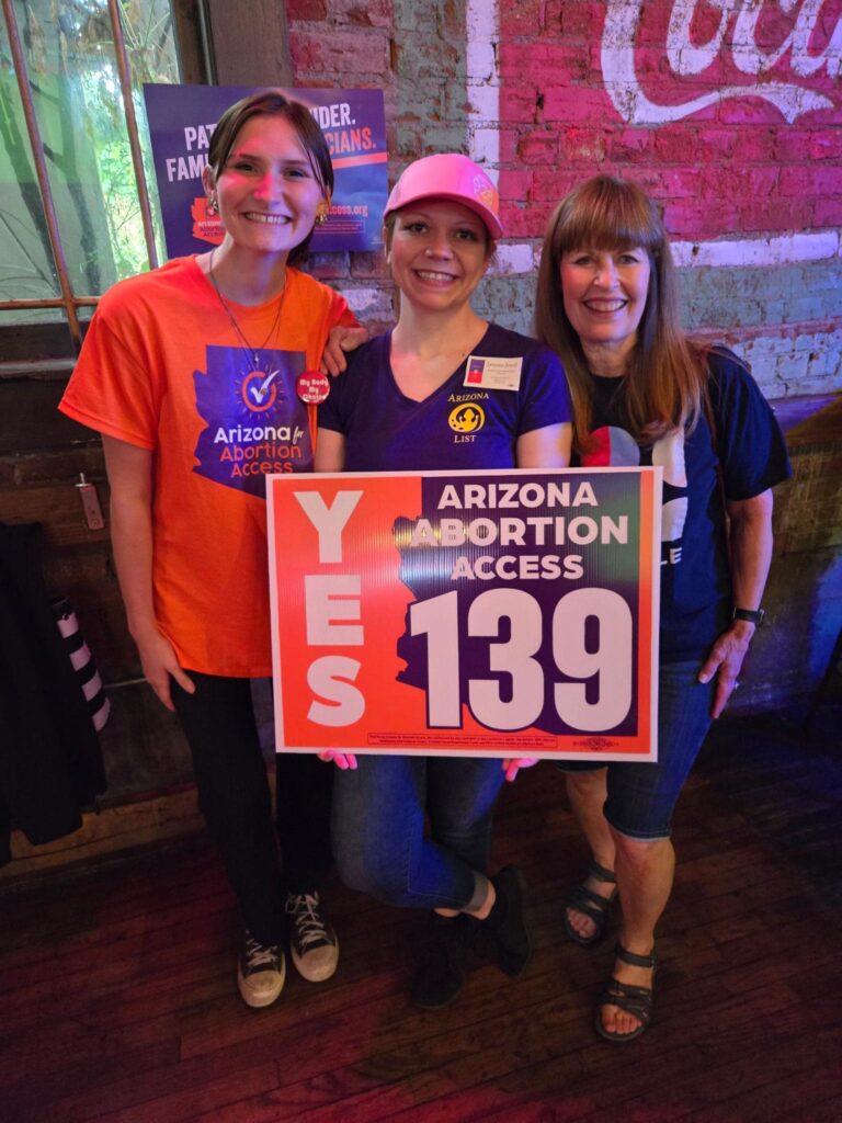 Three Arizona Abortion Access volunteers in Flagstaff, AZ posing for a photo before canvassing for yes on prop 139